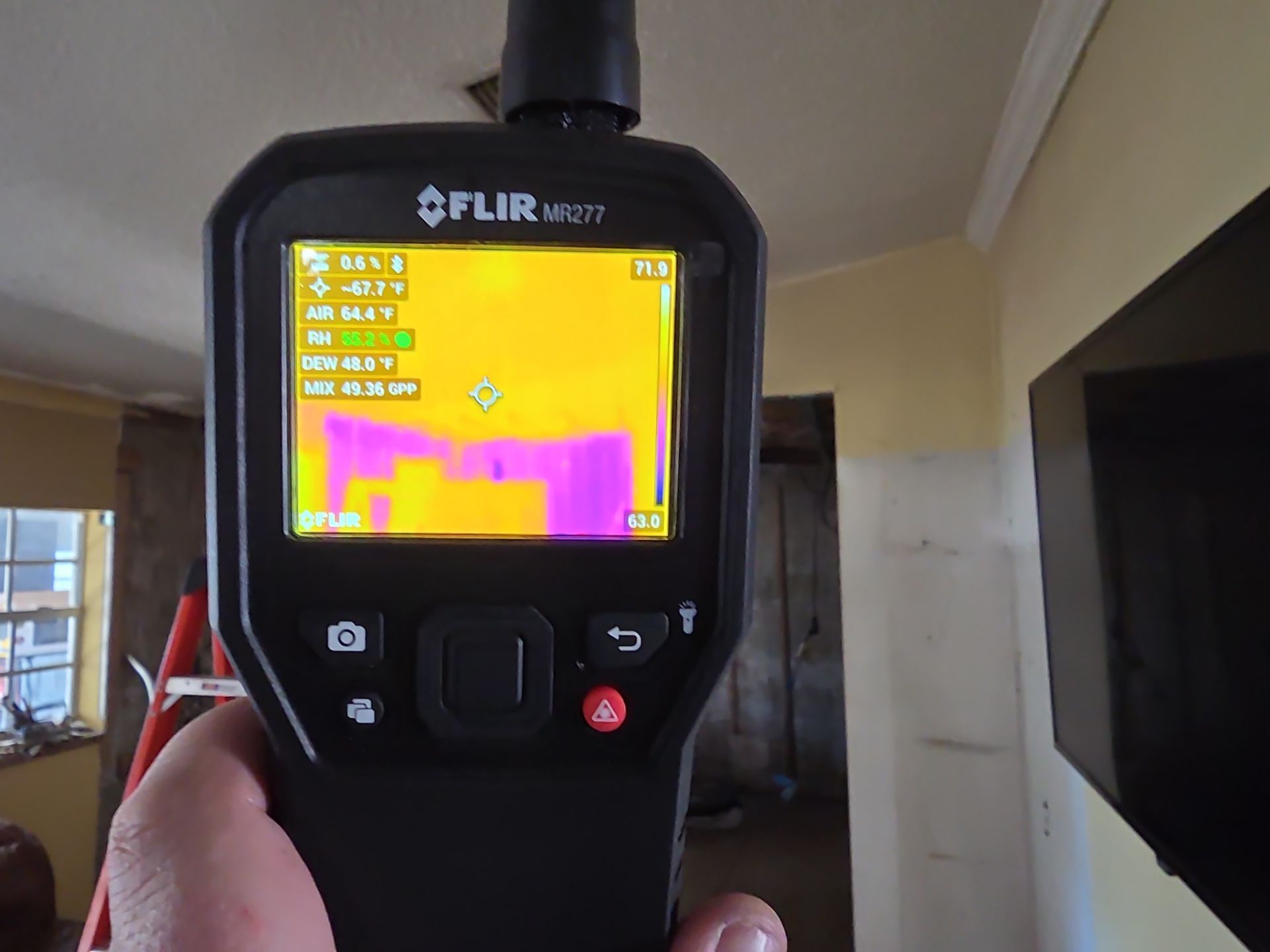 FLIR thermal imaging camera used to detect hidden moisture after fire damage